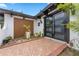 Welcoming home entrance with a modern black double door and brick-paved walkway at 409 San Sebastian Prado, Altamonte Springs, FL 32714