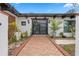 Stylish home entrance featuring double doors, brick walkway, and lush, decorative plants at 409 San Sebastian Prado, Altamonte Springs, FL 32714