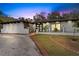 Charming single-story home with a white stucco exterior, dark trim, and manicured landscaping at 409 San Sebastian Prado, Altamonte Springs, FL 32714