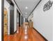 Long hallway featuring hardwood floors, arched doorways, and stylish decor at 409 San Sebastian Prado, Altamonte Springs, FL 32714