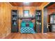 Living room with wood paneling, built in shelves, and view of the fireplace at 409 San Sebastian Prado, Altamonte Springs, FL 32714