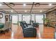 The living room features a black leather recliner sofa, hardwood floors and a tray ceiling at 409 San Sebastian Prado, Altamonte Springs, FL 32714