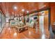Open-concept living room with couches, wood ceilings, hardwood floors, and spiral staircase at 409 San Sebastian Prado, Altamonte Springs, FL 32714