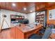Home office with hardwood floors, wood paneling, and custom desk and shelving at 409 San Sebastian Prado, Altamonte Springs, FL 32714
