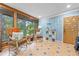 Sunroom with tiled floors, cozy seating, and large windows with wooded views at 409 San Sebastian Prado, Altamonte Springs, FL 32714