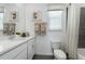 Well-lit bathroom with vanity, framed mirrors, toilet, and shower/tub combo at 426 Belmond Dr, Debary, FL 32713