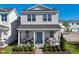 Beautiful two-story home with a cozy front porch, rocking chairs, and attractive landscaping at 426 Belmond Dr, Debary, FL 32713