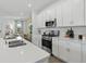 Kitchen island with seating and modern stainless steel appliances provides functionality and style at 426 Belmond Dr, Debary, FL 32713