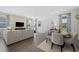 Open-concept living and dining area with stylish furnishings and hardwood floors at 426 Belmond Dr, Debary, FL 32713