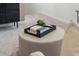 Sitting area with an upholstered ottoman and a tray of coffee table books at 426 Belmond Dr, Debary, FL 32713