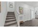 Carpeted staircase leads to the upper level with art and a sliding glass door to the patio at 426 Belmond Dr, Debary, FL 32713