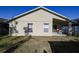View of the home's exterior with a covered patio perfect for outdoor relaxation at 443 S Observatory Dr, Orlando, FL 32835