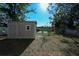 Backyard featuring a storage shed near the fence and view of the water beyond at 443 S Observatory Dr, Orlando, FL 32835