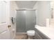 Bright bathroom featuring a tiled floor, enclosed shower, bright neutral wall color and modern vanity at 443 S Observatory Dr, Orlando, FL 32835