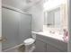 Bathroom featuring a shower with sliding glass doors and decorative mirror over the vanity at 443 S Observatory Dr, Orlando, FL 32835