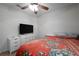Bedroom with ceiling fan, TV, and closet for ample storage at 443 S Observatory Dr, Orlando, FL 32835
