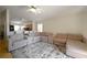 Open-concept living area with sectional couch adjacent to the kitchen, perfect for entertaining at 443 S Observatory Dr, Orlando, FL 32835