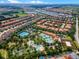 Community aerial showcases a large pool, tennis courts, green landscaping, and tile-roofed homes at 4722 Terrasonesta Dr, Davenport, FL 33837