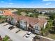 Aerial view of townhomes showcasing well-maintained landscaping, dedicated parking, and tile roofs in a serene neighborhood setting at 4722 Terrasonesta Dr, Davenport, FL 33837