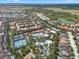 Aerial view of a resort-style community with a pool, tennis courts, and a lazy river at 4722 Terrasonesta Dr, Davenport, FL 33837