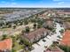 Expansive aerial view of a residential community showcasing well-maintained homes with beautiful landscaping, and lush greenery at 4722 Terrasonesta Dr, Davenport, FL 33837