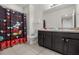 Bathroom featuring granite countertops, dark cabinets and a shower/tub combo at 4722 Terrasonesta Dr, Davenport, FL 33837