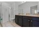 Clean bathroom with a glass-enclosed shower, tile flooring, and a dual sink vanity at 4722 Terrasonesta Dr, Davenport, FL 33837