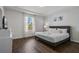 Stylish bedroom with a large window, tray ceiling, and decorative accent wall at 4722 Terrasonesta Dr, Davenport, FL 33837