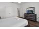 Cozy bedroom with a dresser, a large closet, and a comfortable bed with fresh white linens at 4722 Terrasonesta Dr, Davenport, FL 33837
