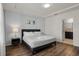 Comfortable bedroom with accent wall, tray ceiling, and ensuite bathroom access at 4722 Terrasonesta Dr, Davenport, FL 33837