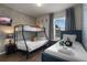 Charming bedroom featuring a bunk bed, a twin bed, and stylish decor at 4722 Terrasonesta Dr, Davenport, FL 33837