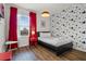 Cozy bedroom with a Mickey Mouse accent wall, bright window, and modern décor at 4722 Terrasonesta Dr, Davenport, FL 33837