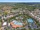 Aerial view showcasing community pool, tennis court, and lush landscaping for recreation and relaxation at 4722 Terrasonesta Dr, Davenport, FL 33837