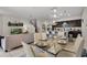 Elegant dining area with modern lighting, glass table, and views of the kitchen and living room at 4722 Terrasonesta Dr, Davenport, FL 33837