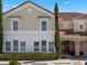 Inviting two-story townhome features a classic facade, a terracotta-tiled roof, and mature landscaping at 4722 Terrasonesta Dr, Davenport, FL 33837
