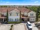 Charming townhome featuring tile roof, lush landscaping, and dedicated parking, creating a welcoming and convenient living space at 4722 Terrasonesta Dr, Davenport, FL 33837