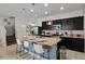 Well-equipped kitchen with dark cabinets, island seating, and modern appliances at 4722 Terrasonesta Dr, Davenport, FL 33837