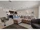 Spacious living area with a comfortable sectional sofa and open layout to the modern kitchen at 4722 Terrasonesta Dr, Davenport, FL 33837