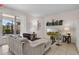 Bright living room with sliding glass doors, neutral paint, tile flooring, and comfortable seating at 4722 Terrasonesta Dr, Davenport, FL 33837
