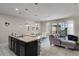 Open-concept kitchen flows into a living area with modern décor and sliding glass doors to the pool at 4722 Terrasonesta Dr, Davenport, FL 33837