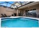 Relaxing pool with in-ground spa, covered patio, and lounge chairs, perfect for soaking up the sun and enjoying outdoor living at 4722 Terrasonesta Dr, Davenport, FL 33837