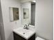 Bathroom featuring a modern vanity, sink, and decorative mirrors at 500 Newell Hill Rd # 109A, Leesburg, FL 34748