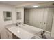 Updated bathroom with a large mirror and a dual-sink vanity featuring a marble countertop at 500 Newell Hill Rd # 109A, Leesburg, FL 34748