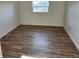 Bedroom with wood floors, a window, and neutral colored walls at 500 Newell Hill Rd # 109A, Leesburg, FL 34748