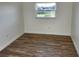 Bedroom with a window letting in natural light and laminate flooring at 500 Newell Hill Rd # 109A, Leesburg, FL 34748