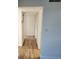 Hallway with wood look floors and multiple closets for ample storage at 500 Newell Hill Rd # 109A, Leesburg, FL 34748