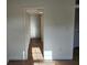 Hallway with wood floors, bi-fold closet doors, and a neutral color palette at 500 Newell Hill Rd # 109A, Leesburg, FL 34748