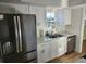 Modern kitchen with stainless steel appliances and bright white cabinets at 500 Newell Hill Rd # 109A, Leesburg, FL 34748
