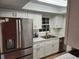 Modern kitchen with stainless steel appliances and bright white cabinets at 500 Newell Hill Rd # 109A, Leesburg, FL 34748