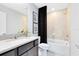 Modern bathroom featuring a sleek vanity, tile shower, and a relaxing bathtub at 5044 Starling Bird Ln, St Cloud, FL 34771